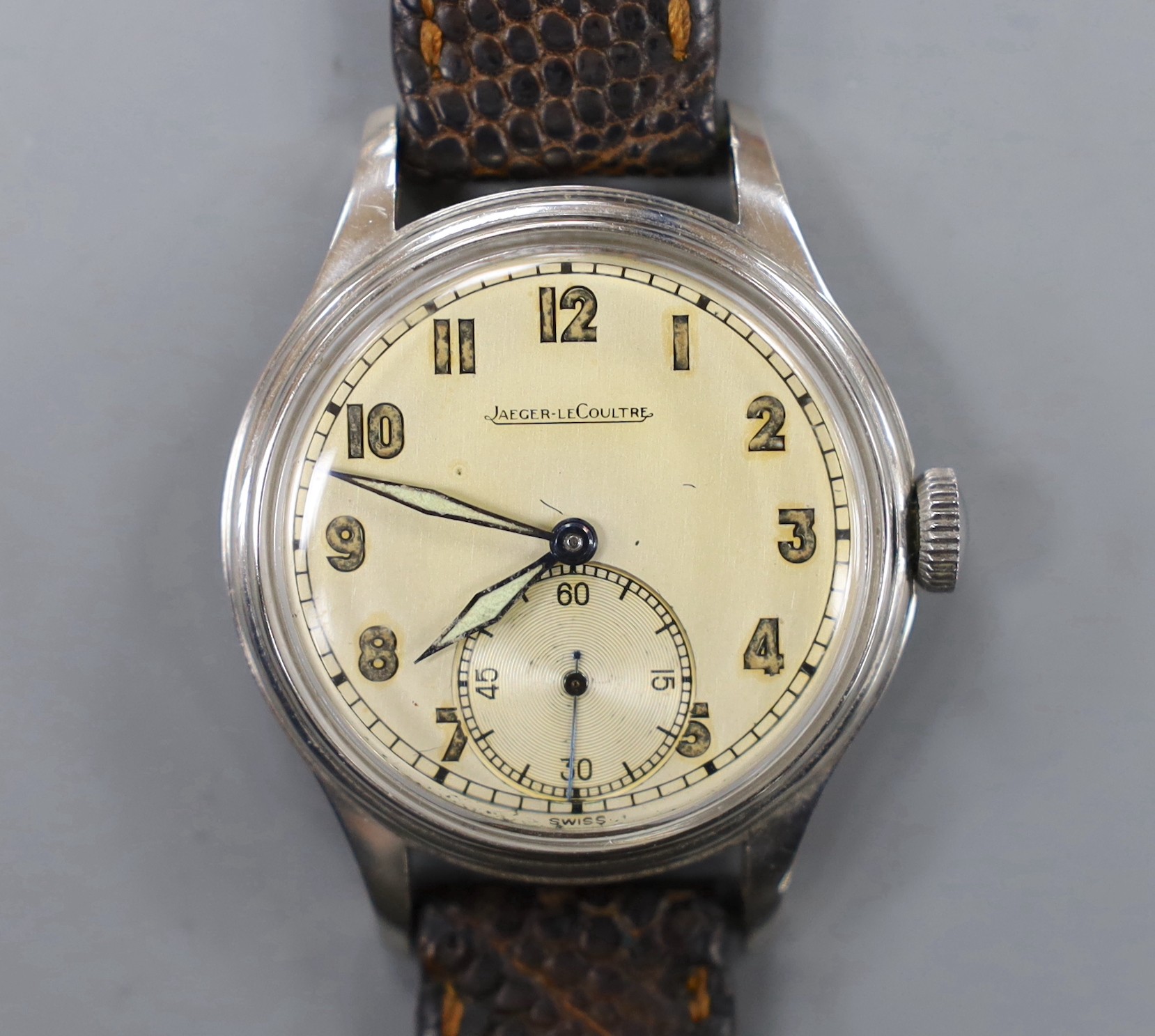 A gentleman's stainless steel Jaeger LeCoultre manual wind wrist watch, with Arabic dial and subsidiary seconds, on associated leather strap.